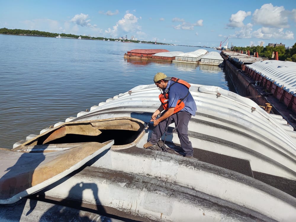 Pulling sample from barge